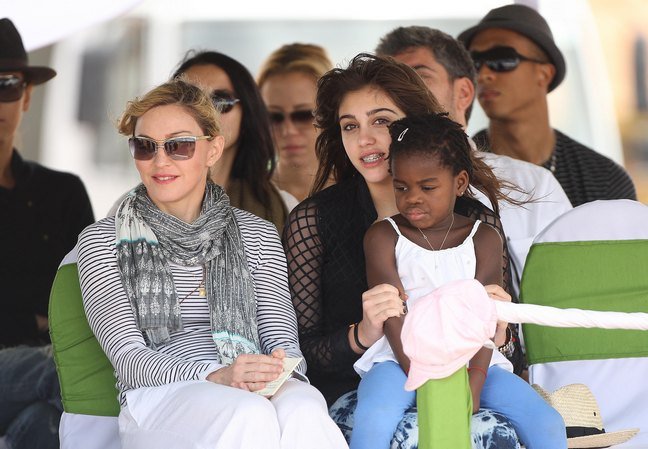 Madonna scarf striped shirt white pants sunglasses